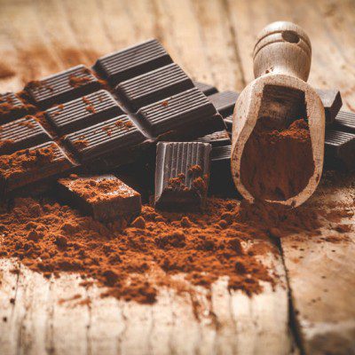 Dark chocolate on a wooden table in vintage style.